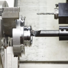 detail turning on metal cutting machine tool at manufacturing factory